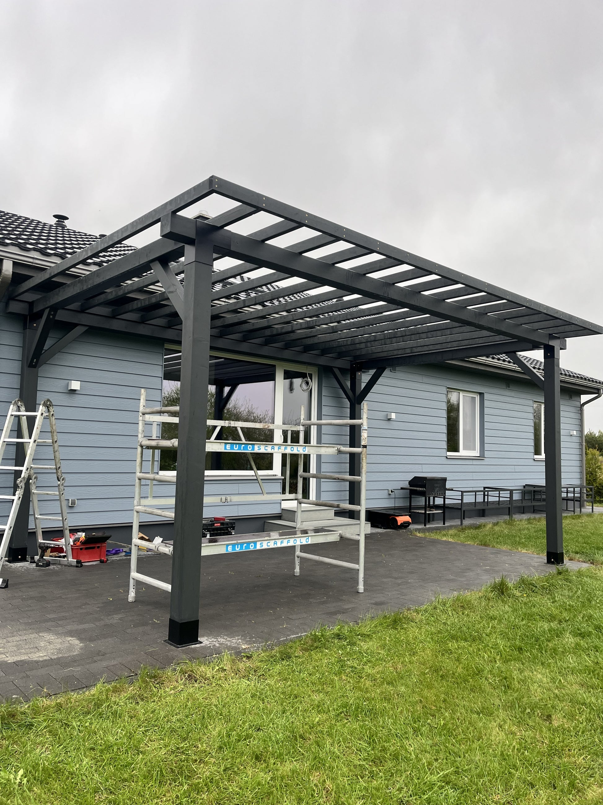 Modular DIY canopy by Terases, 6m x 4m, showing the assembled frame and fabric cover in a backyard setting.