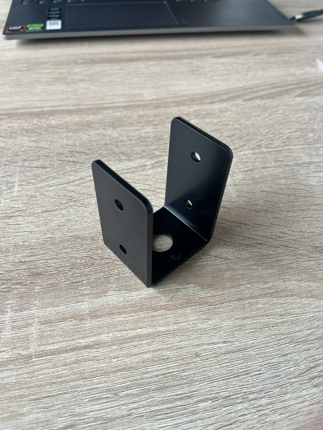 Terases Beam in Place support bracket for 45mm lumber, shown installed on wooden framing in a construction setting.