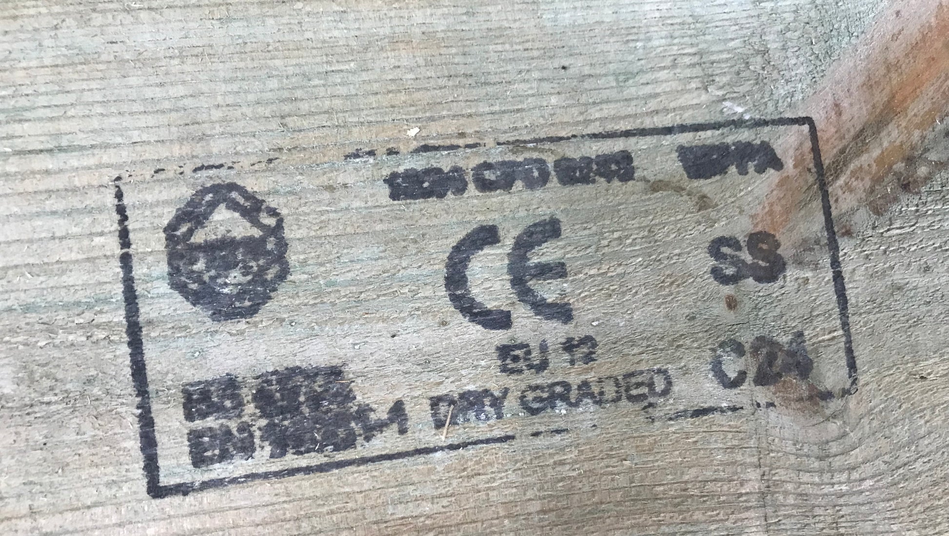 CE marking and other certification logos on a textured surface