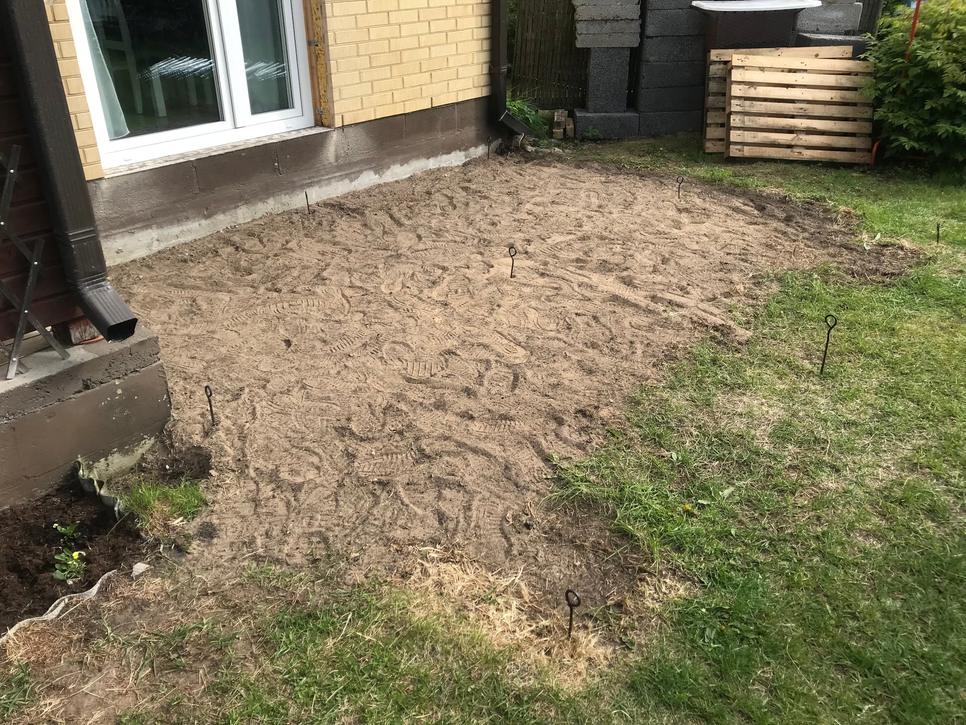 Partial excavation of a garden area in front of a house