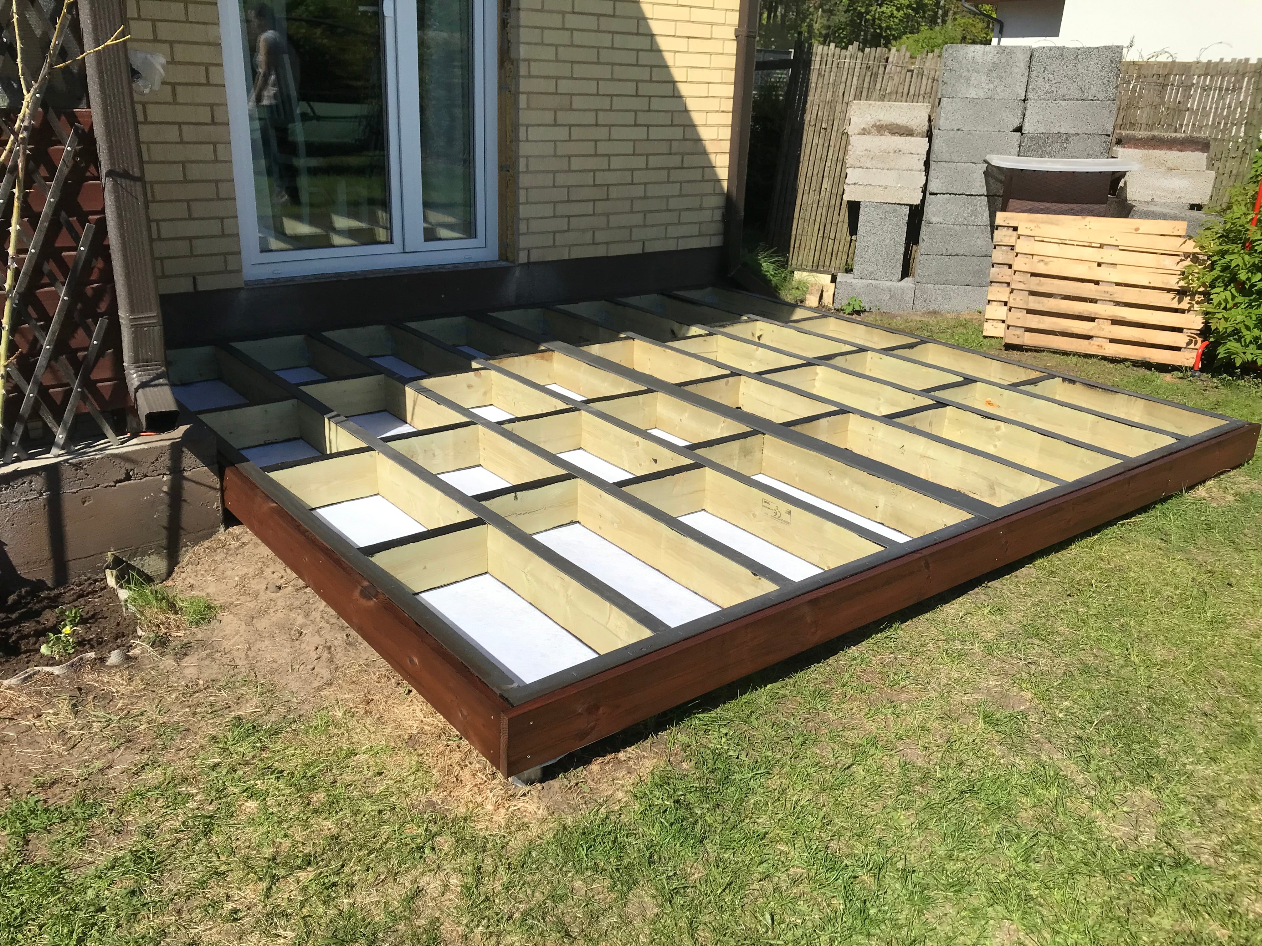 Wooden deck foundation being built in a backyard