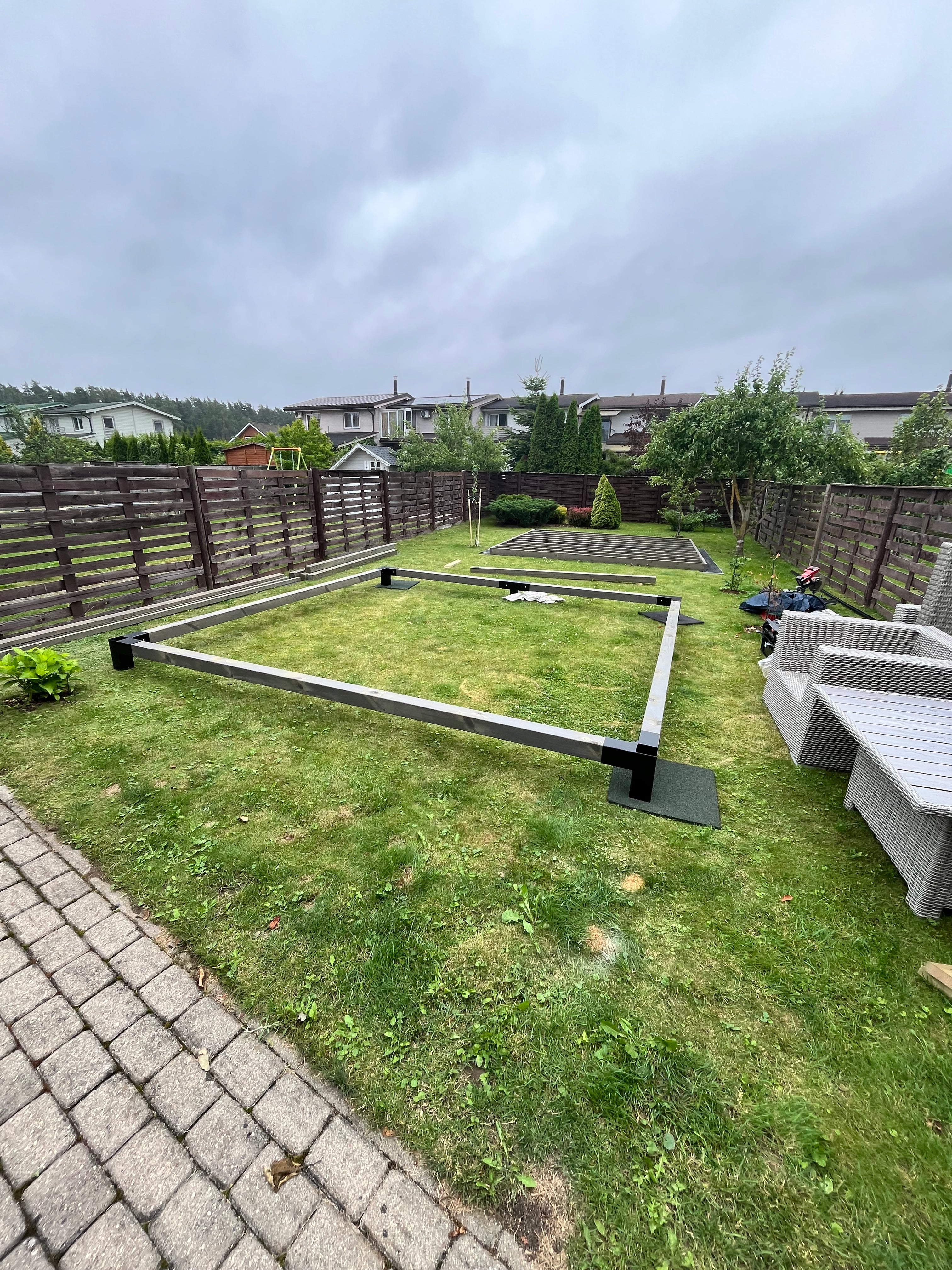 Metal gate in a grassy area with a cloudy sky