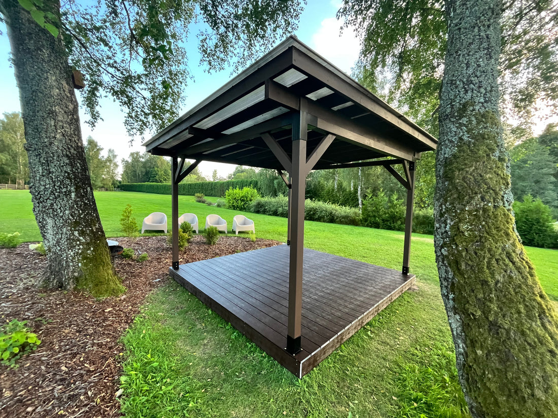 Wooden gazebo in a garden setting with trees and greenery.