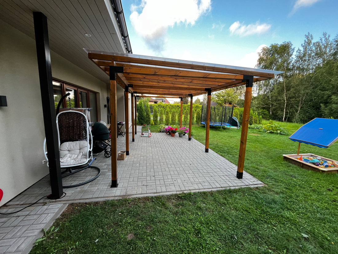 Patio with wooden pergola, outdoor furniture, and surfboard against a blue sky.