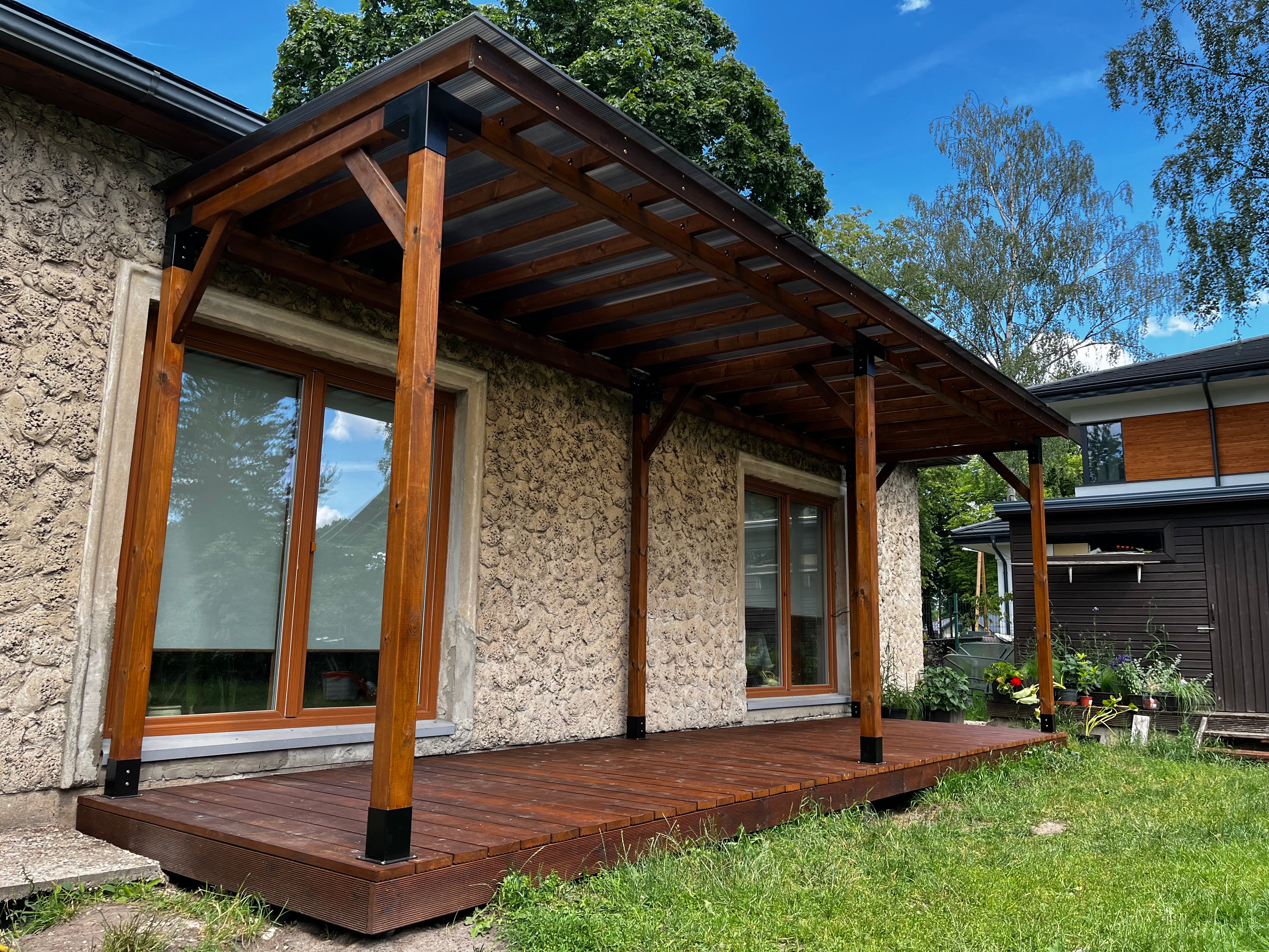Modern house with stone facade and wooden deck