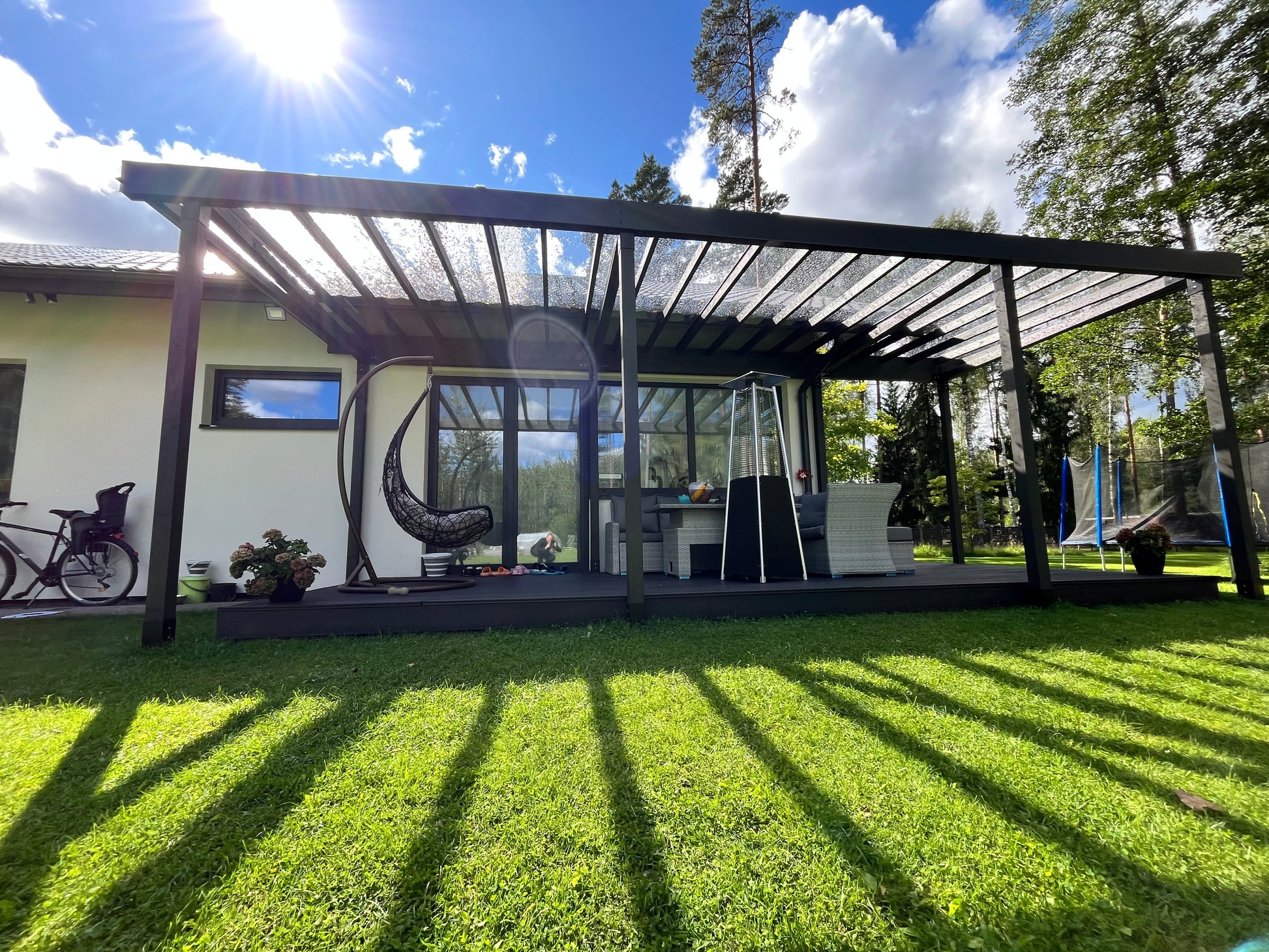 Pergola structure with outdoor furniture and decor on a sunny day