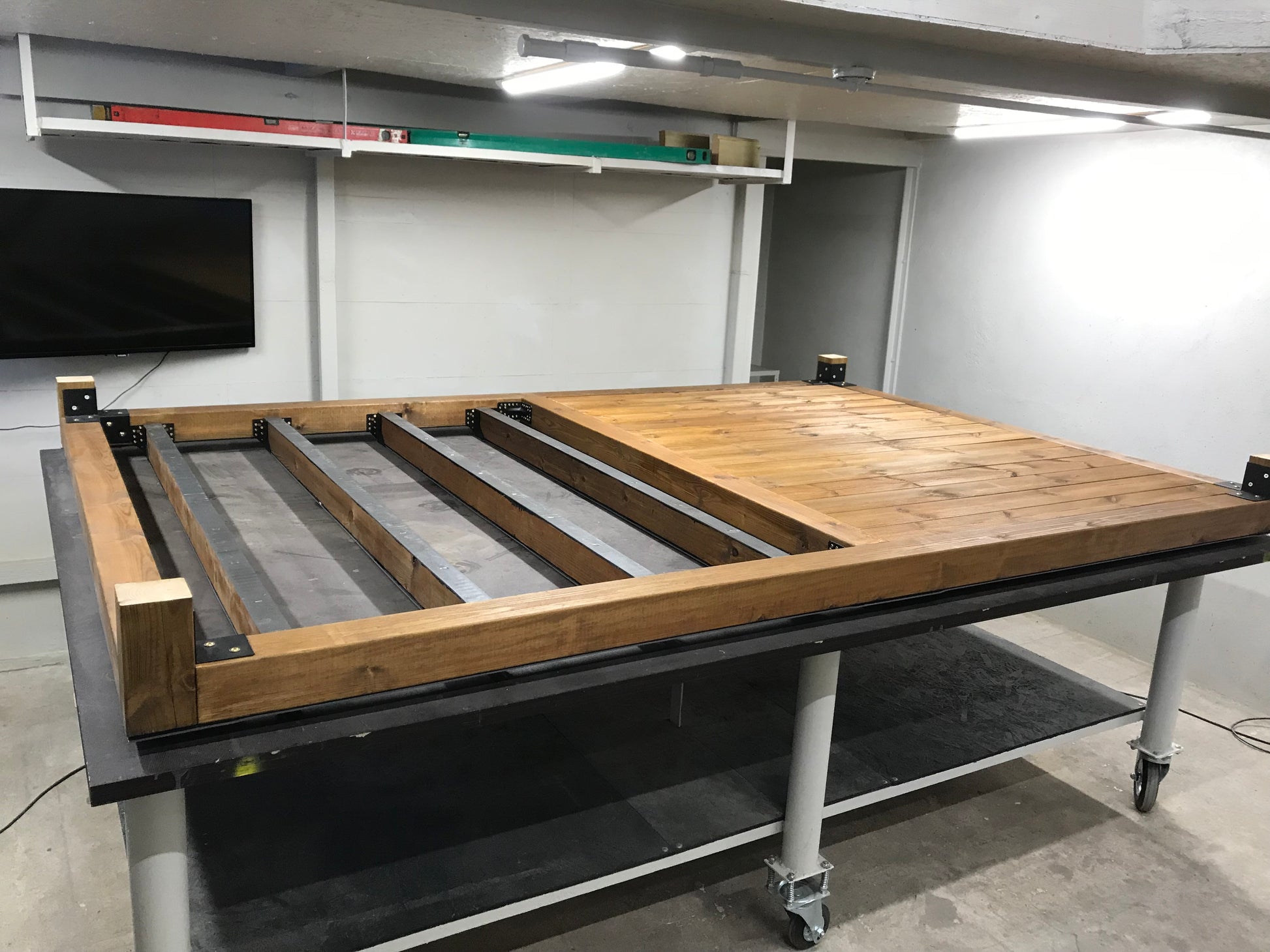 Wooden workbench with metal frame in a workshop setting