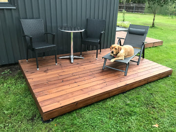 Wooden deck with outdoor furniture and a dog relaxing