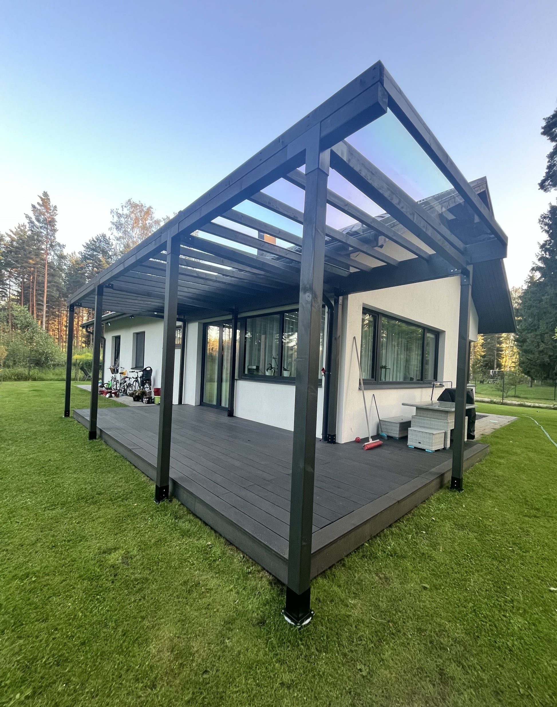Patio cover with wooden deck in a backyard setting