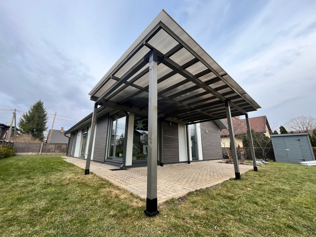 Modern carport attached to a house with a clear sky background