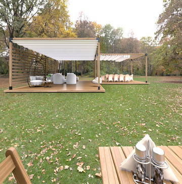 Outdoor seating area with wooden pergola and tables on a grassy field