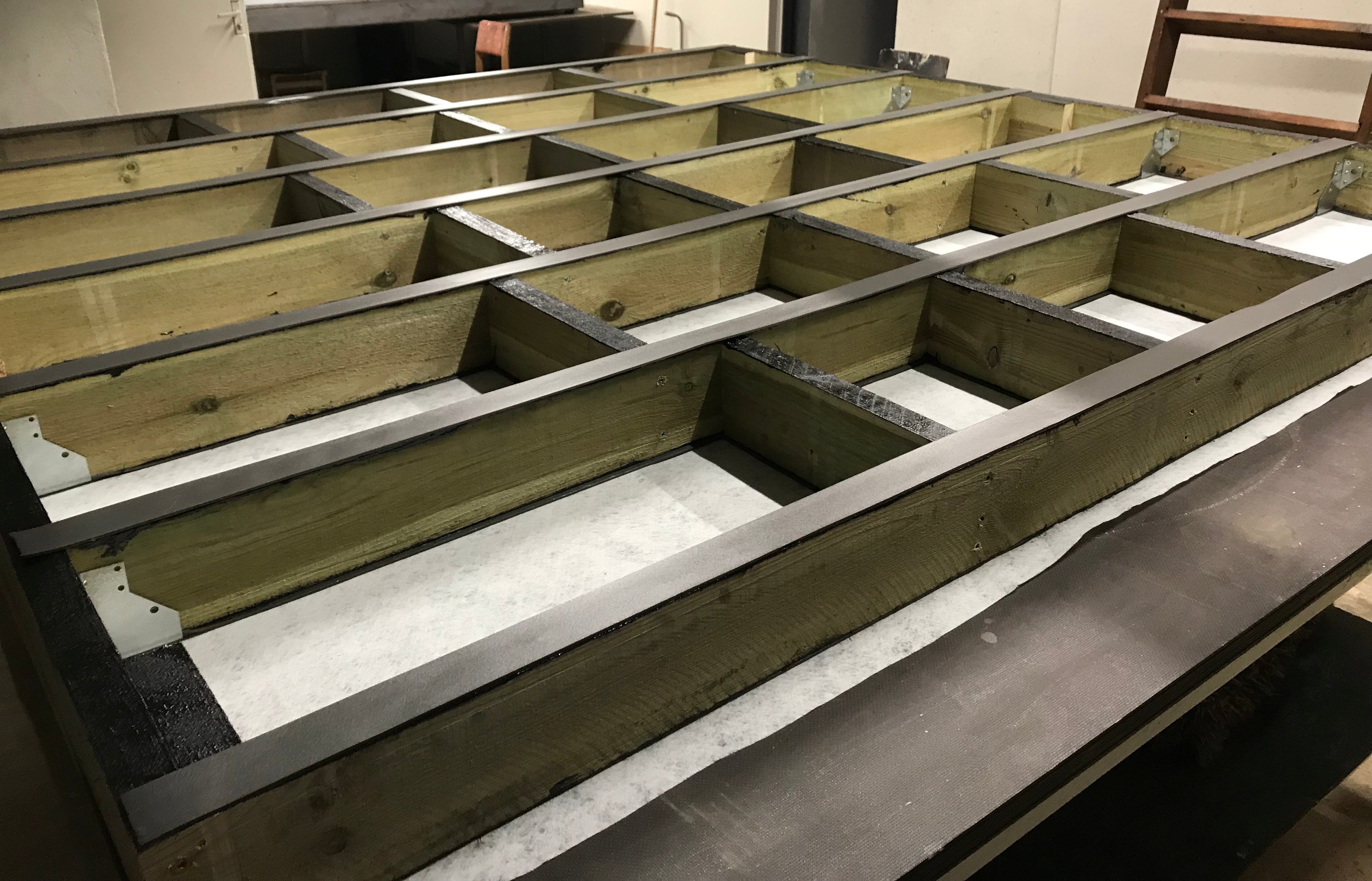 Wooden beams with metal brackets on table