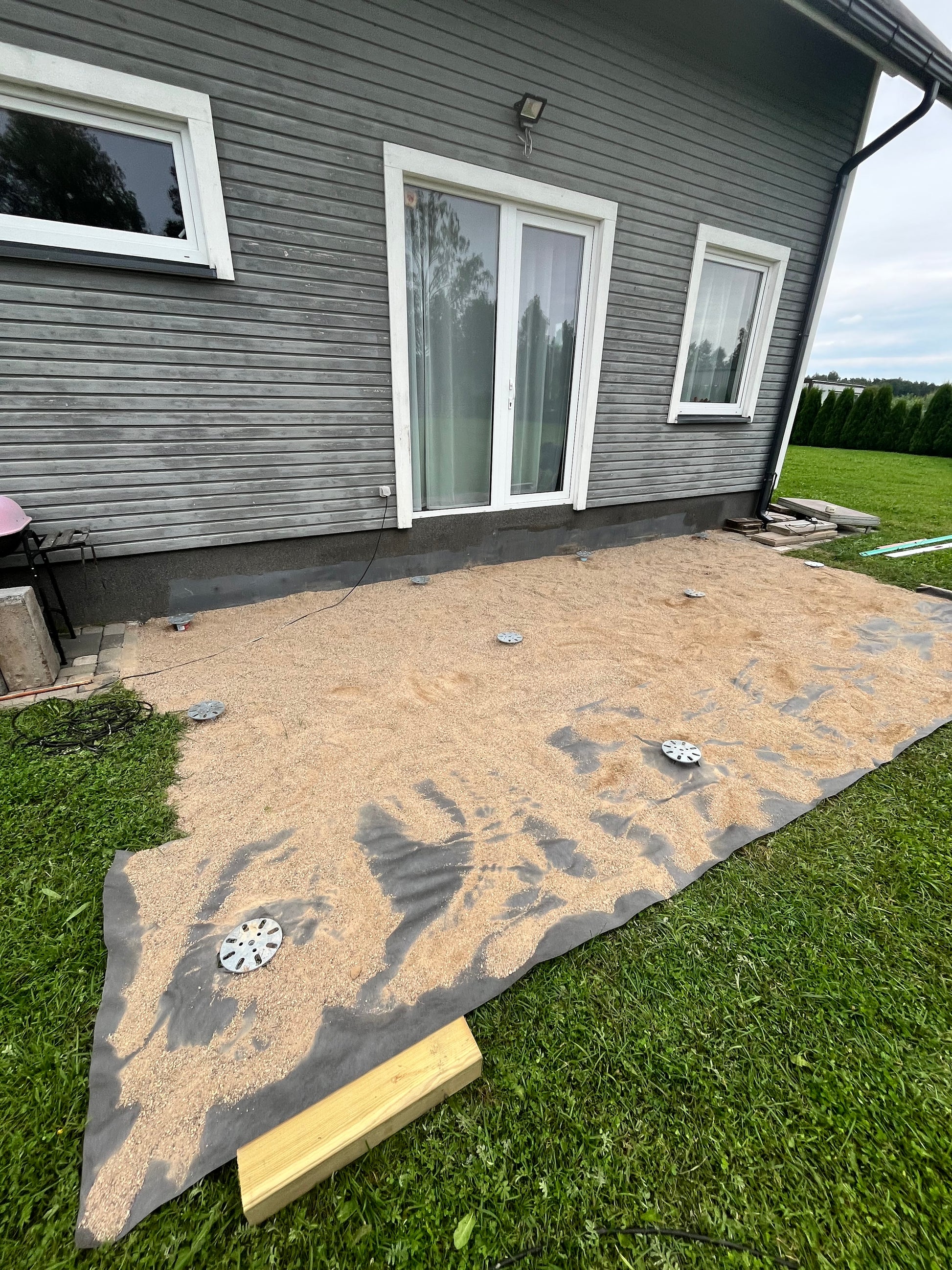 House exterior with a newly installed screw piles for deck