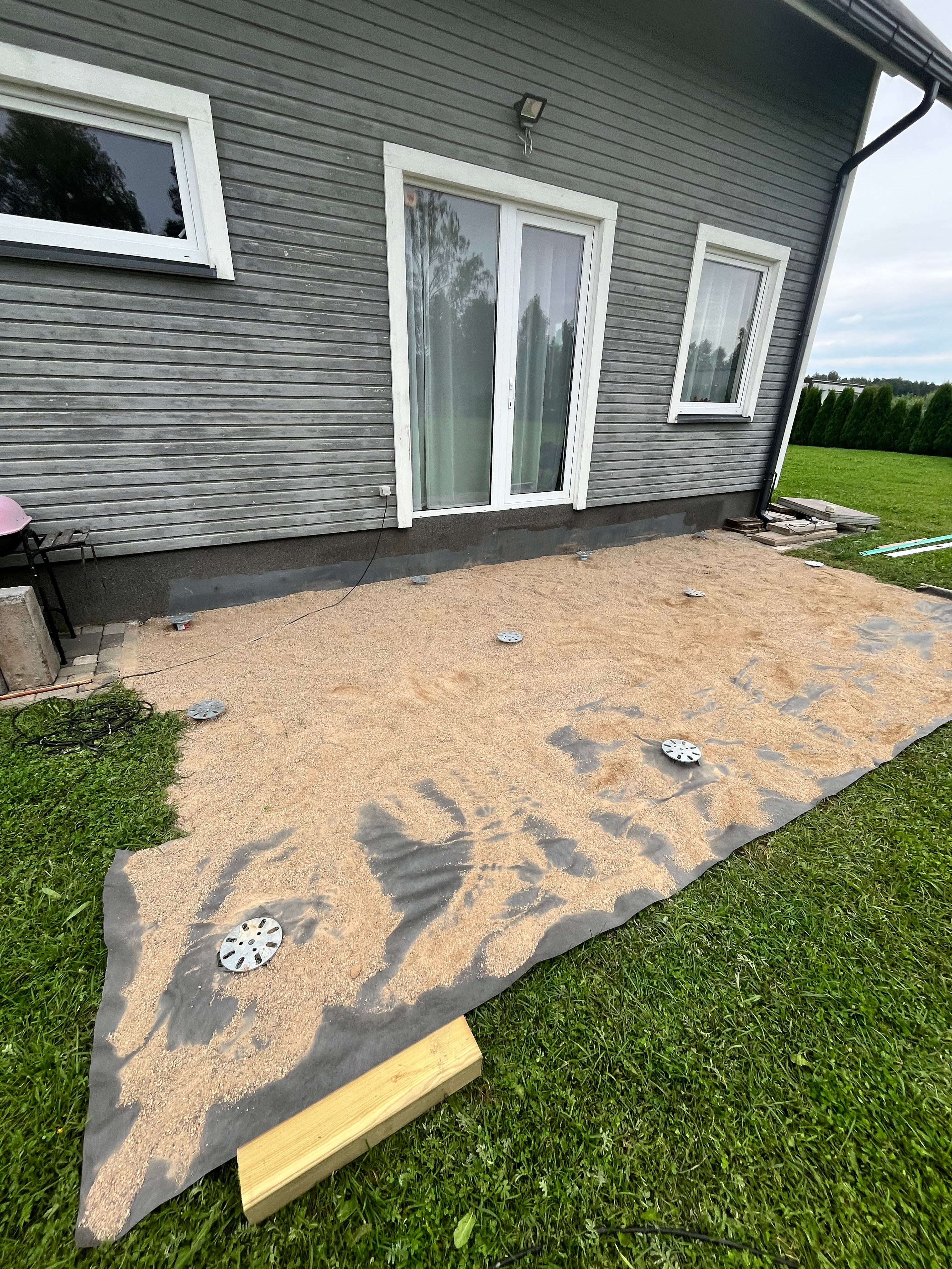 House exterior with a newly installed screw piles for deck