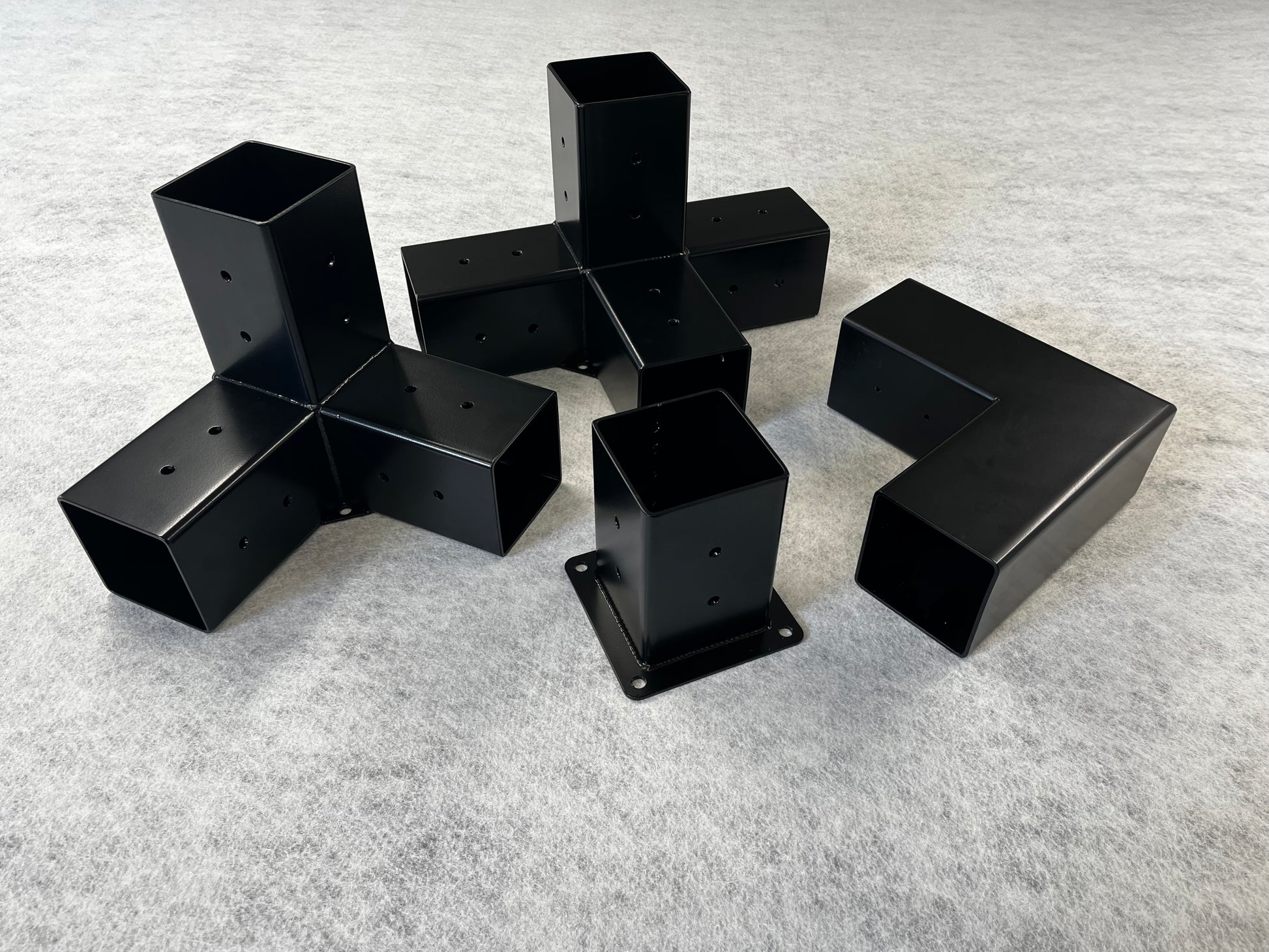 Black metal furniture legs on a gray surface