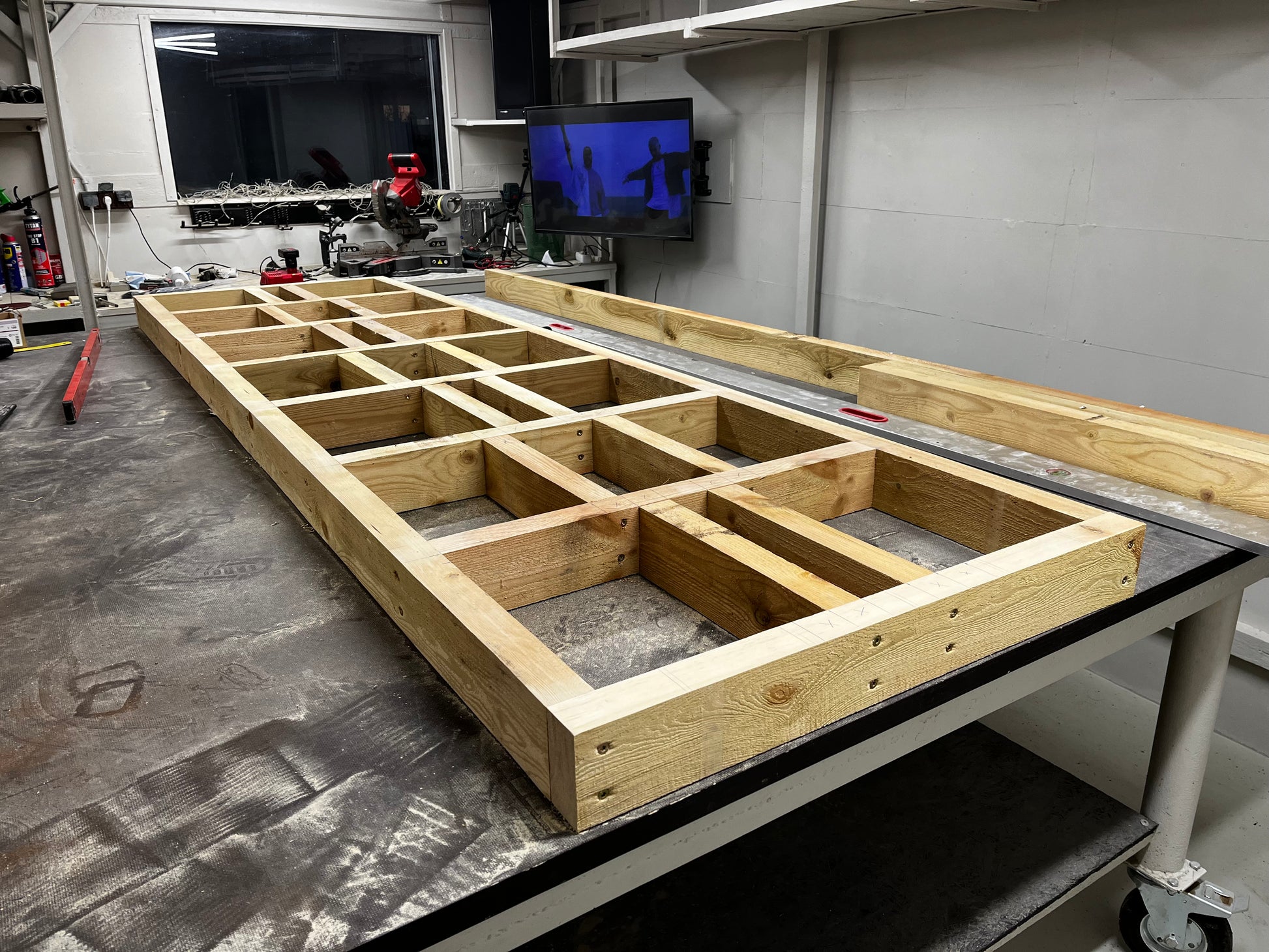 Wooden frame structure on a workbench in a workshop setting