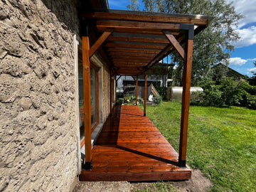 Wooden deck with a stone wall and garden view