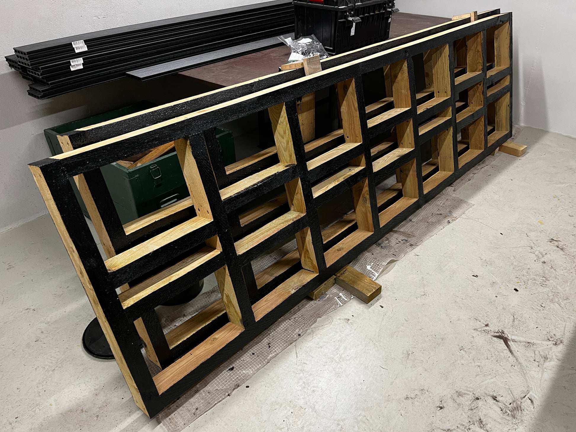 Wooden deck with geometric design on a concrete floor