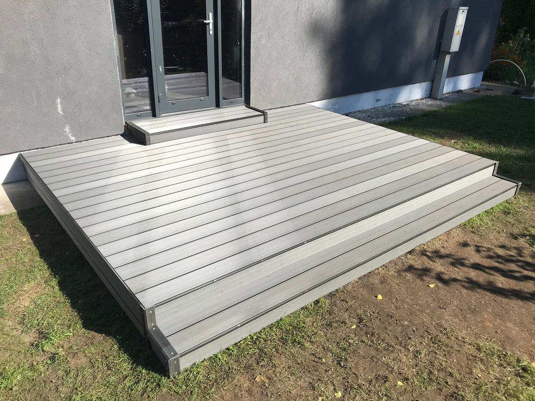 Gray wooden deck leading to a house entrance