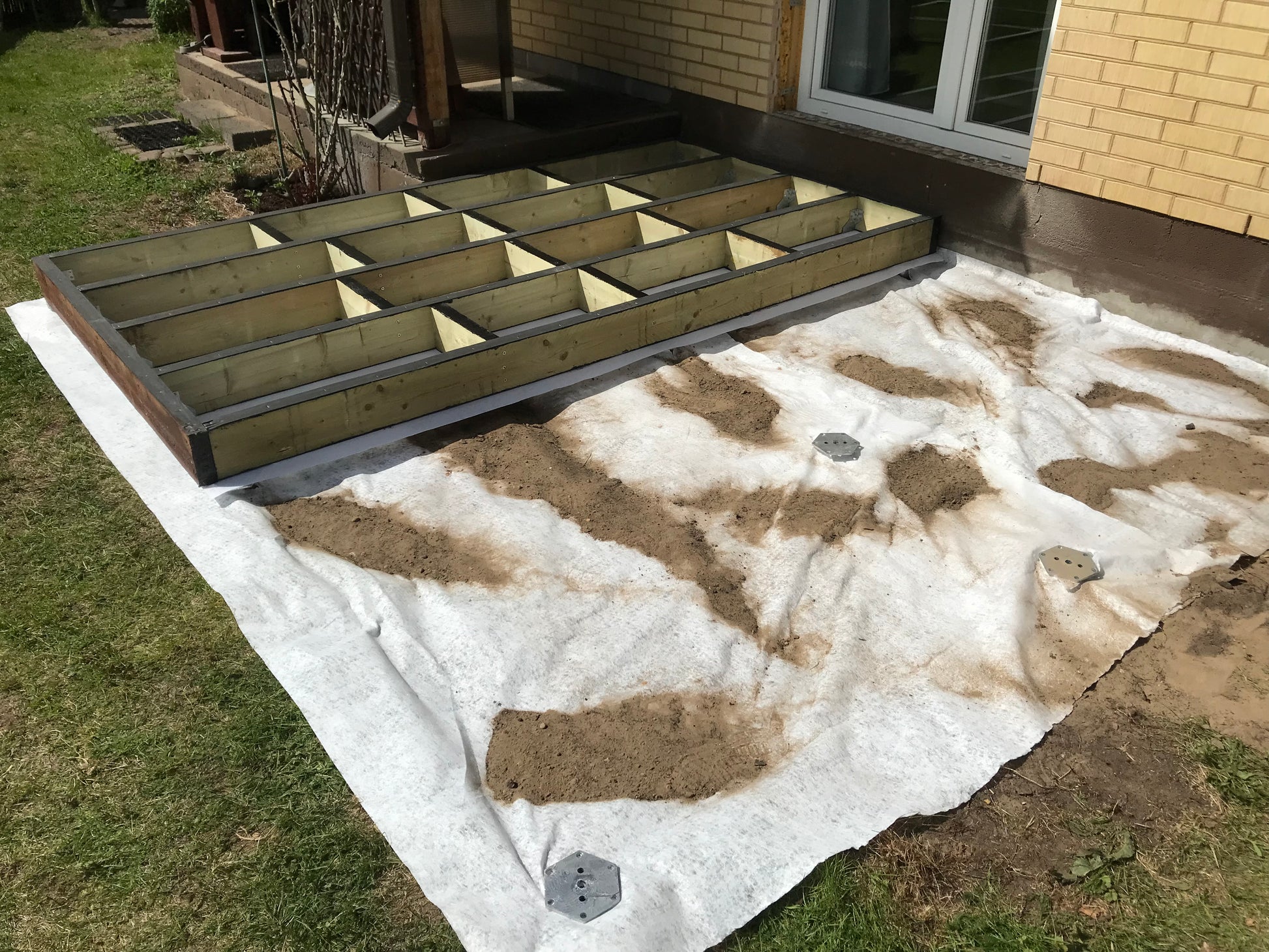 Foundation form for a concrete patio or driveway in front of a house.