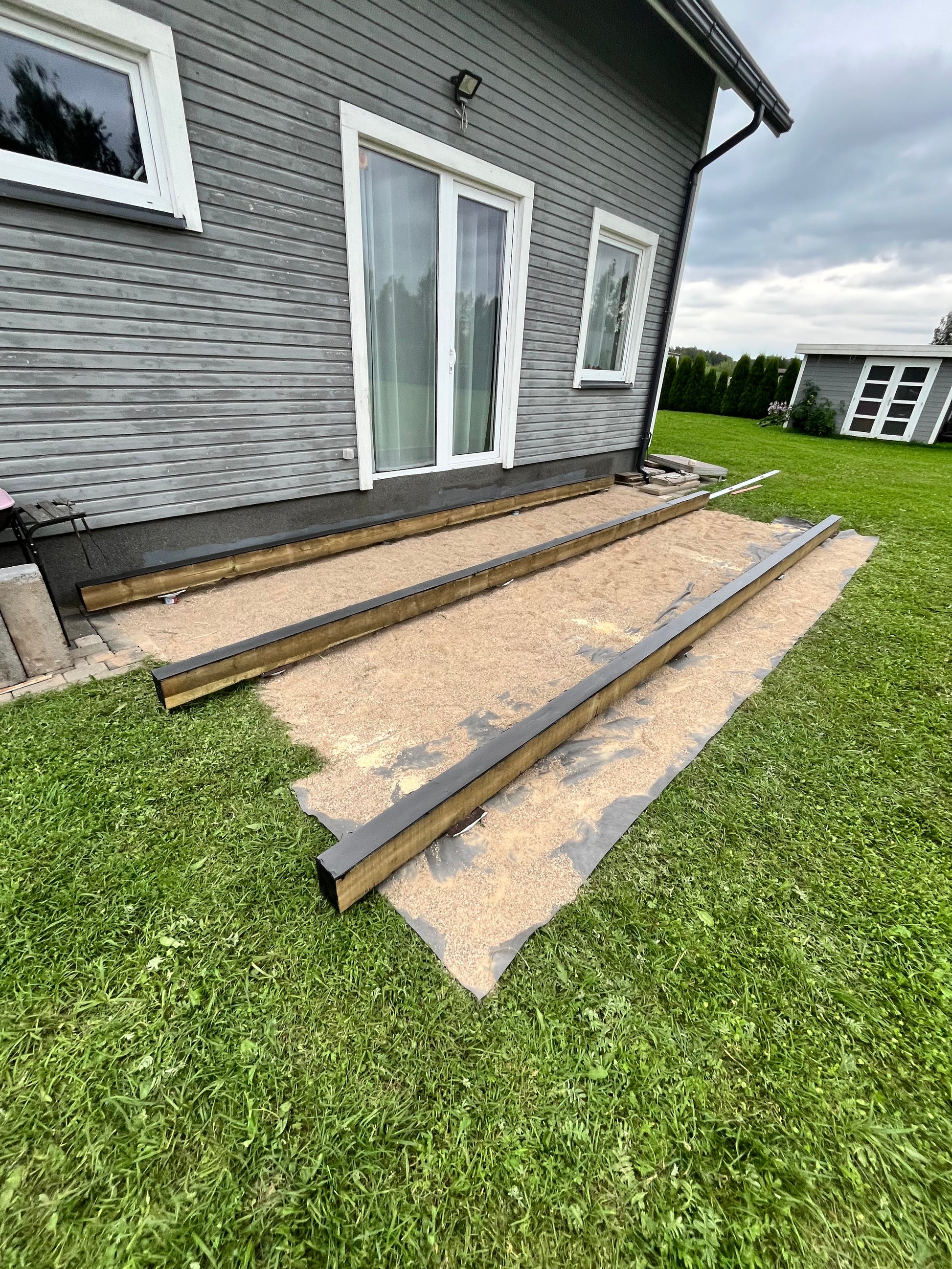 House exterior with a newly installed roof and gutters on a grassy lawn.