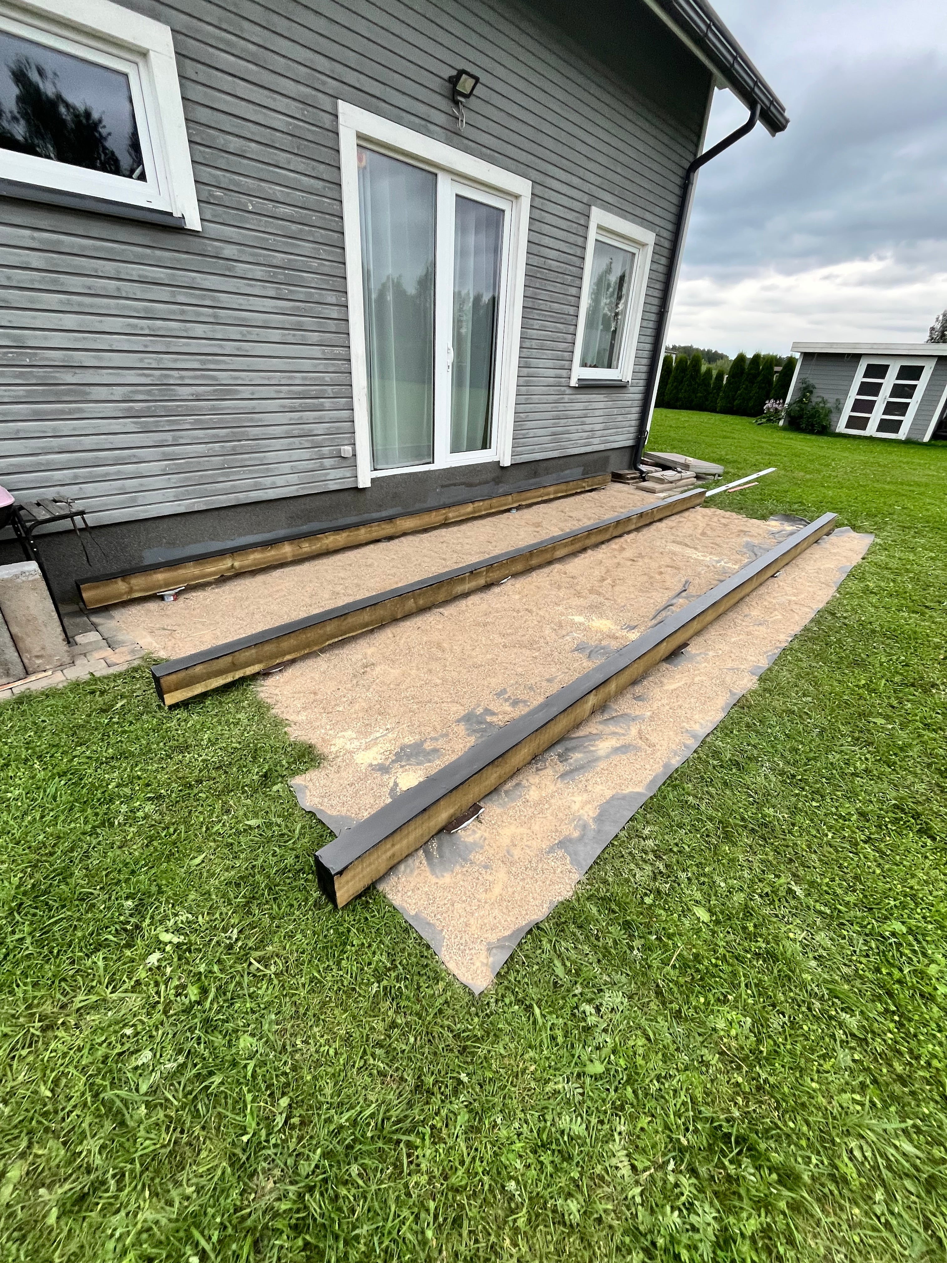 House exterior with a newly installed roof and gutters on a grassy lawn.