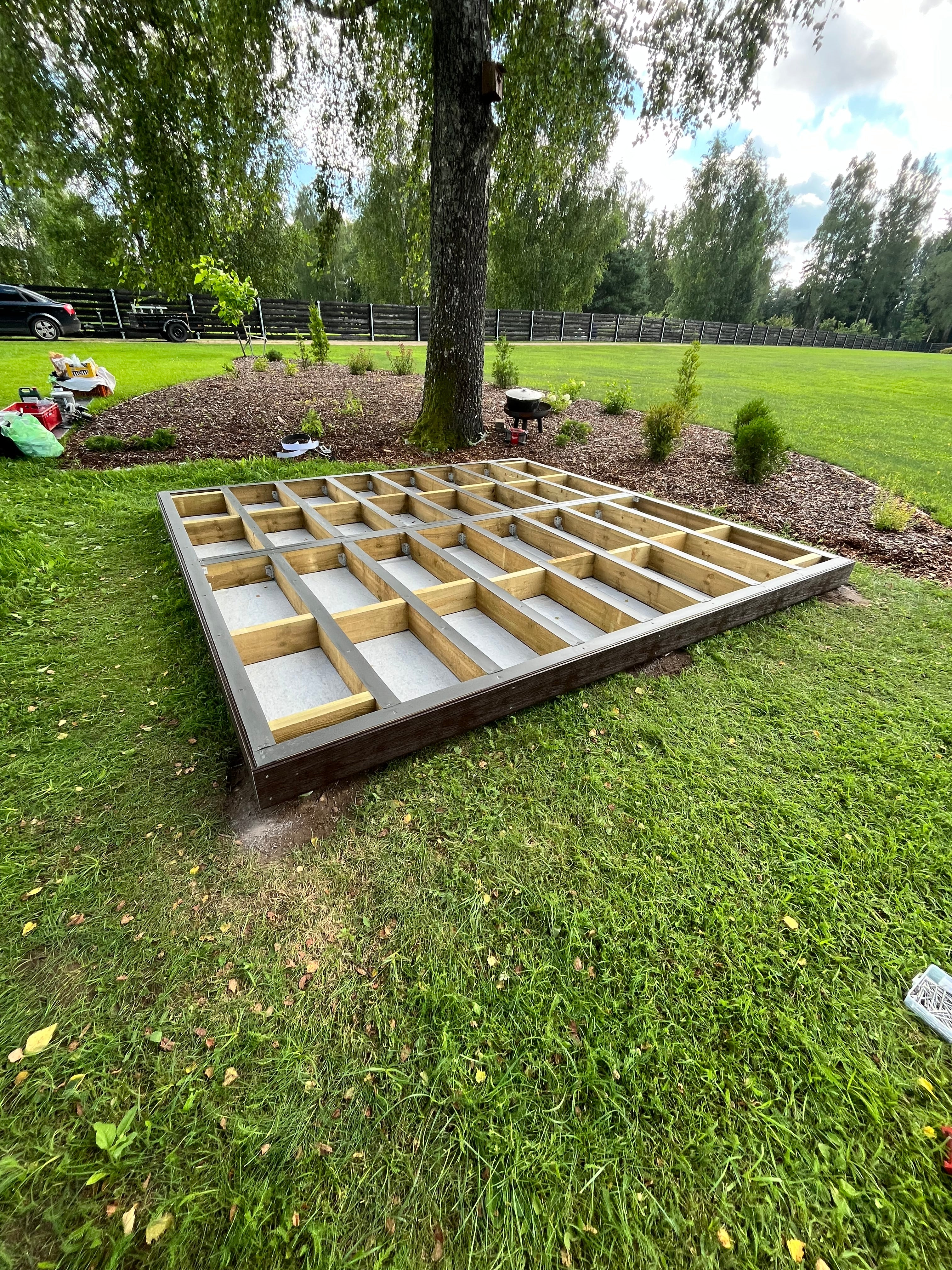 Wooden wpc deck on a grassy area