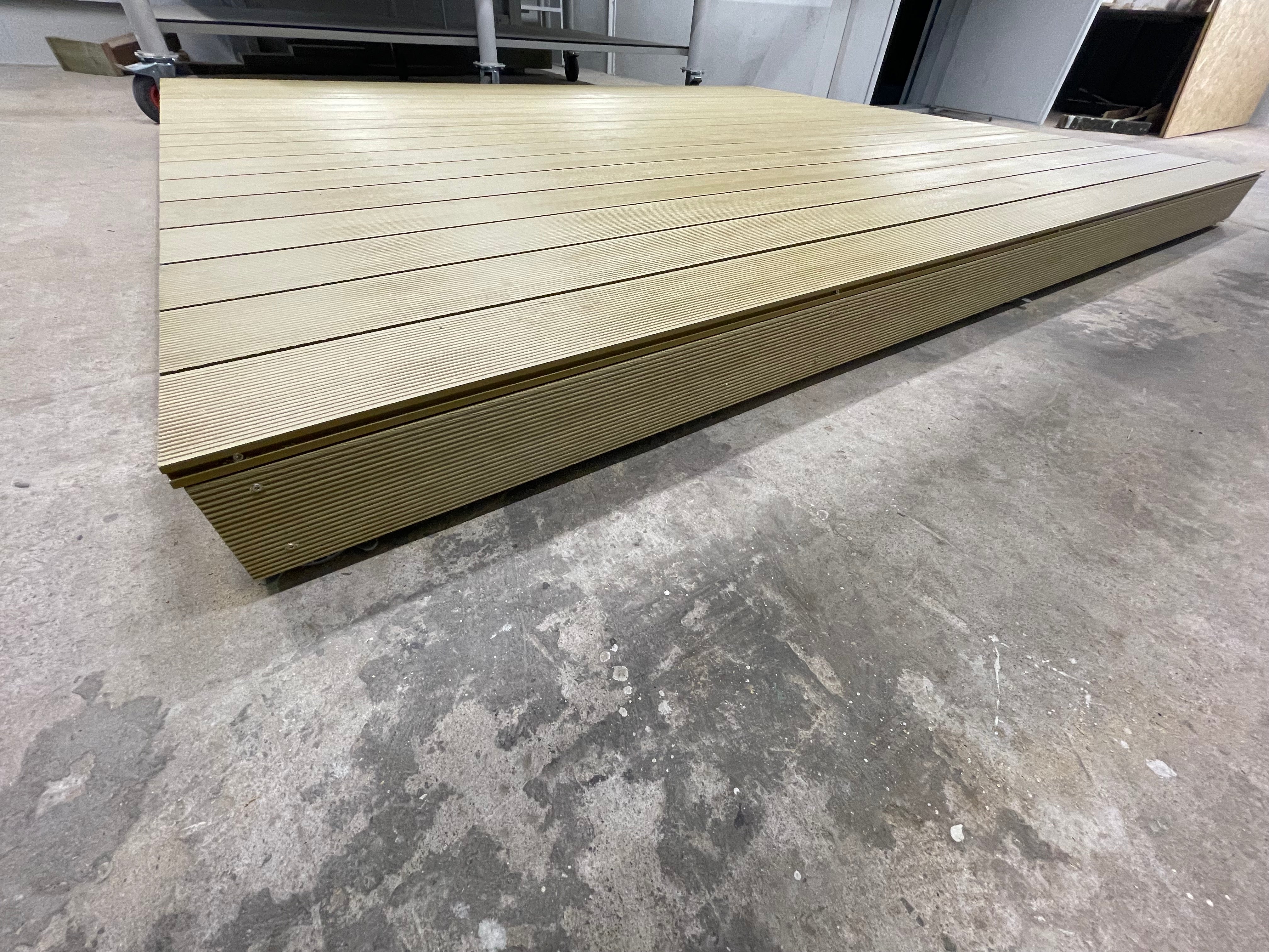 Wooden deck board on a concrete floor